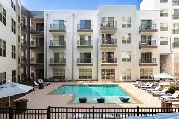 a pool is in front of an apartment building
